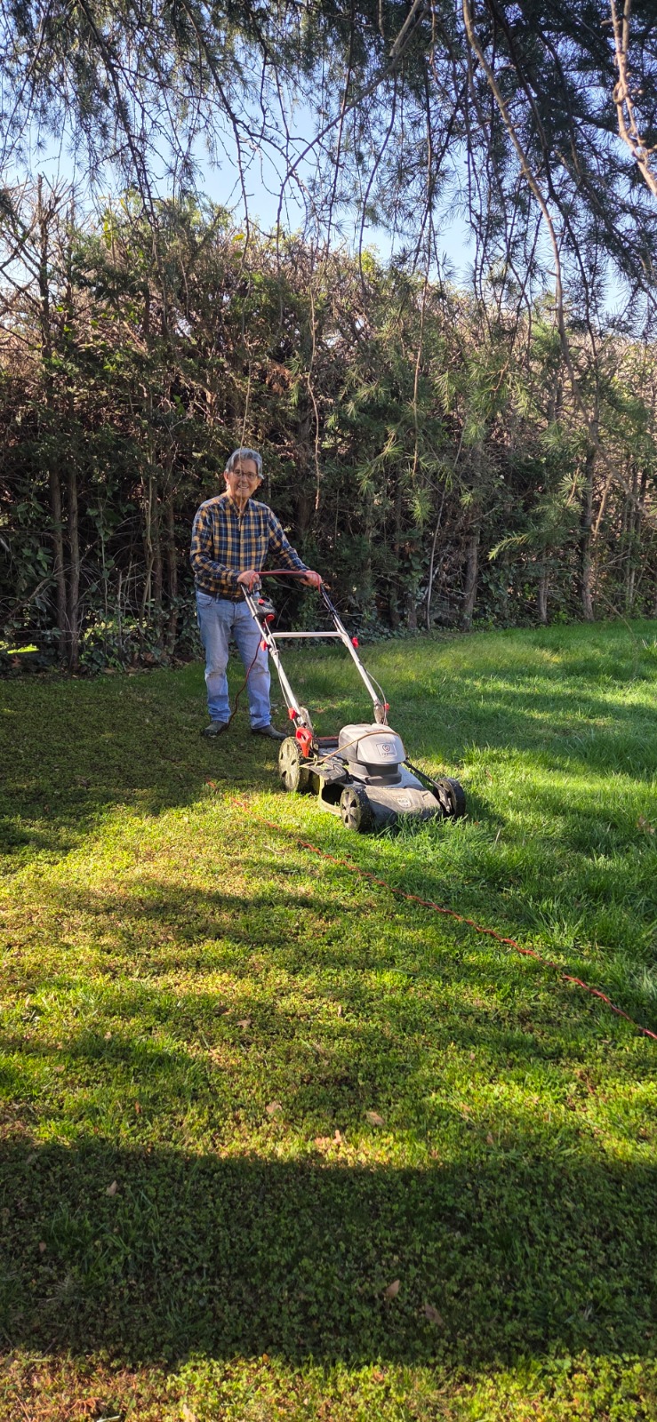Eladio mowing the lawn