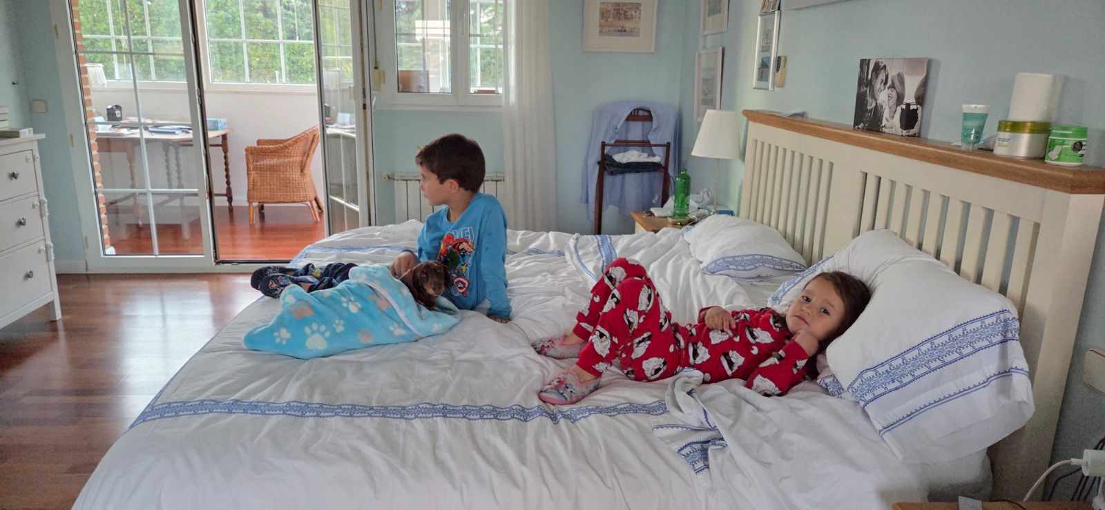 The kids in their pyjamas on our bed with Pippa on Friday night